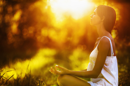 Yoga woman meditating at sunset. Female model meditating in serene harmony