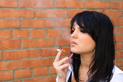 beautiful woman smokes a cigarette